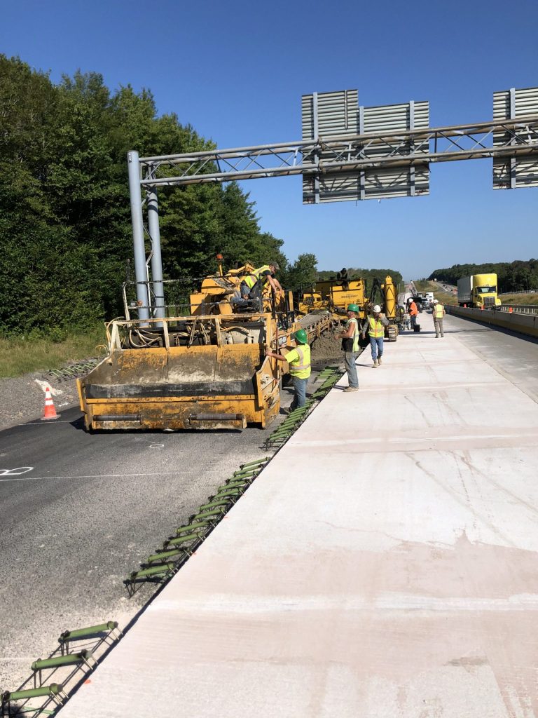Workers smoothing highway road